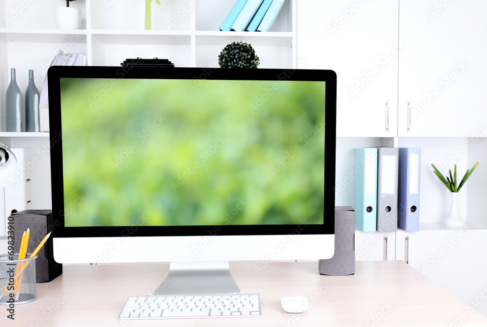 Fototapeta premium Computer with screensaver on table