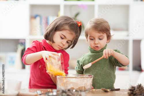 Two kids cooking at home.