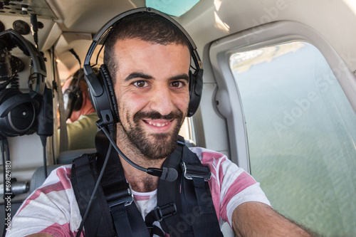 Young Man Taking Selfie in Helicopter Cabin While Flying © william87
