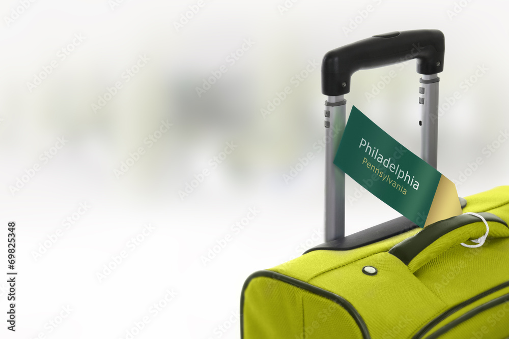 Fototapeta premium Philadelphia, Pennsylvania. Green suitcase with label.