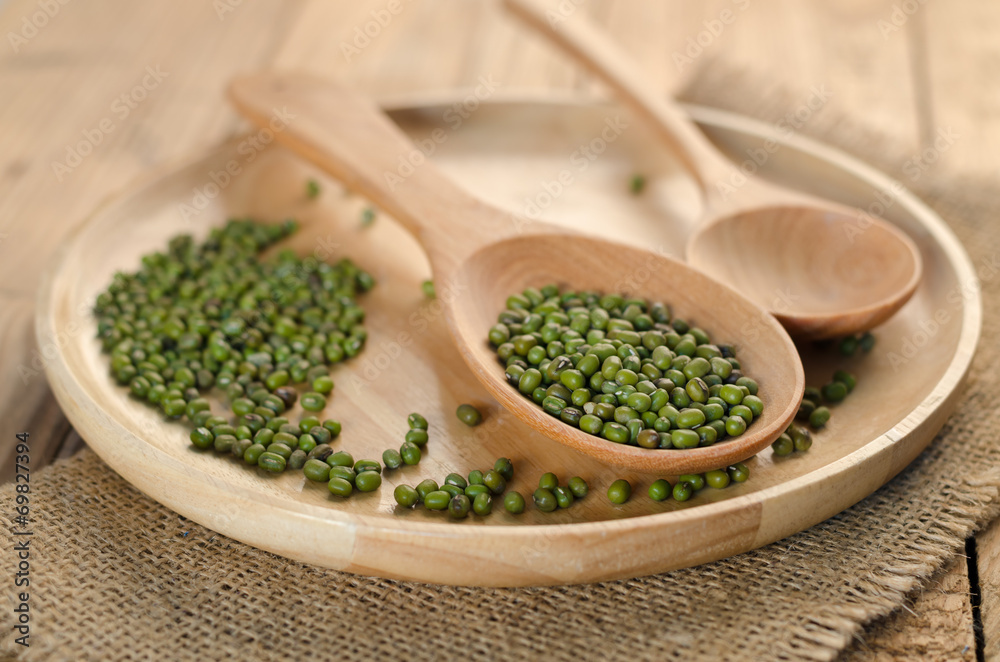 Mungbeans with wooden plate and wooden spoon Mungbeans with wooden plate and wooden spoon
