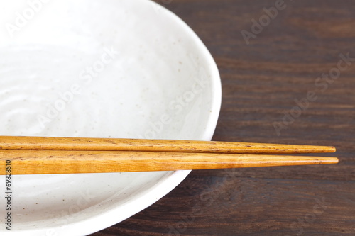 Close - up brown wooden chopsticks on table wood background