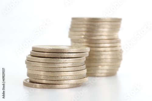 Silver coins stack on a white background