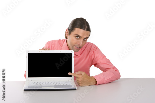 young man with laptop pointing at the monitor over white backgro © kalcutta