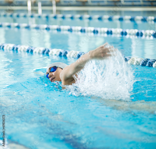 Young girl in goggles swimming front crawl stroke style © mr.markin