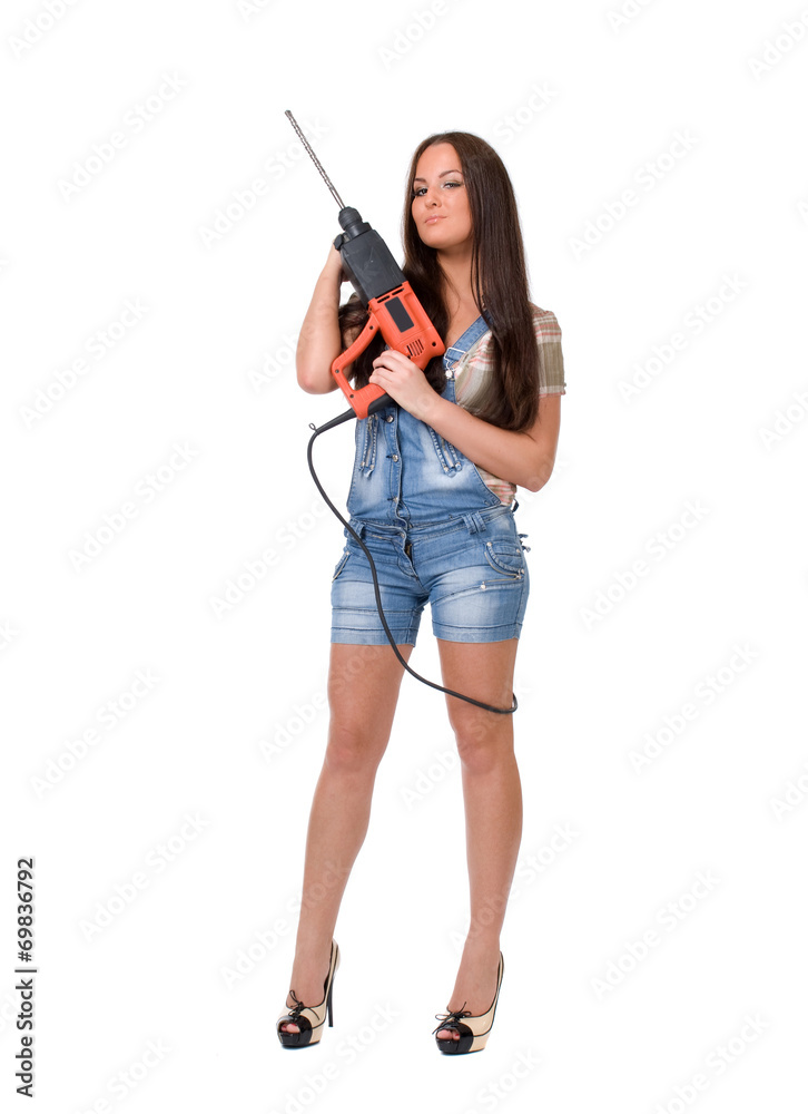 Young woman in jeans witch electric hammer drill.Isolated. Young woman in jeans witch electric hammer drill.Isolated.