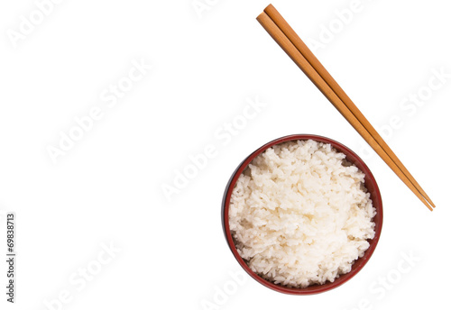 A bowl of rice and a pair of chopstick over white background