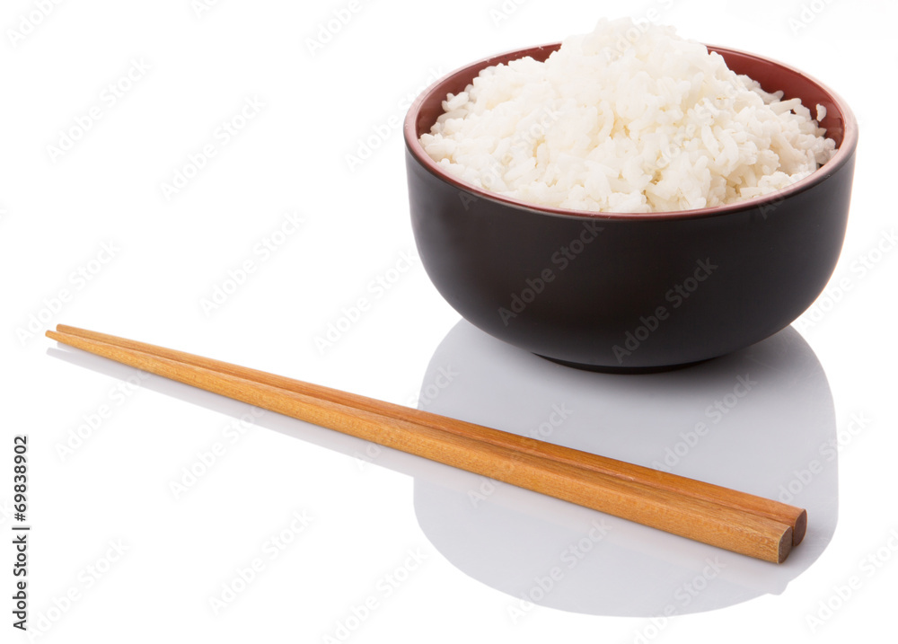 A bowl of rice and a pair of chopstick over white background A bowl of rice and a pair of chopstick over white background