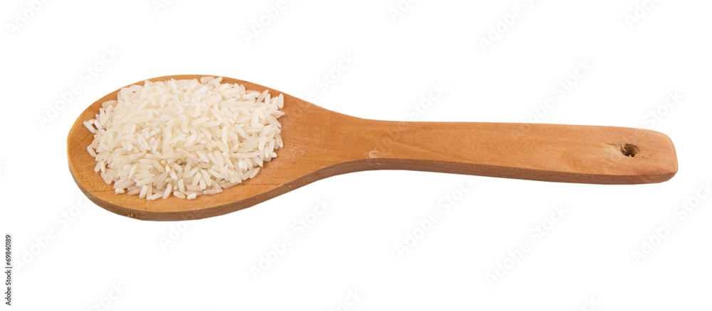 Raw and uncooked rice in wooden spoon over white background Raw and uncooked rice in wooden spoon over white background