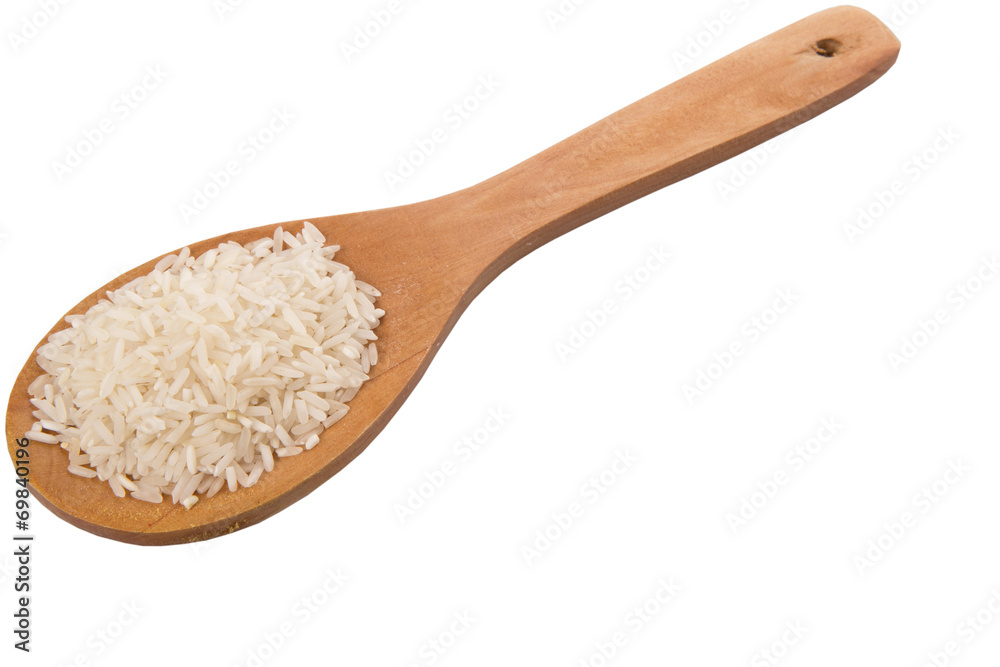 Raw and uncooked rice in wooden spoon over white background Raw and uncooked rice in wooden spoon over white background