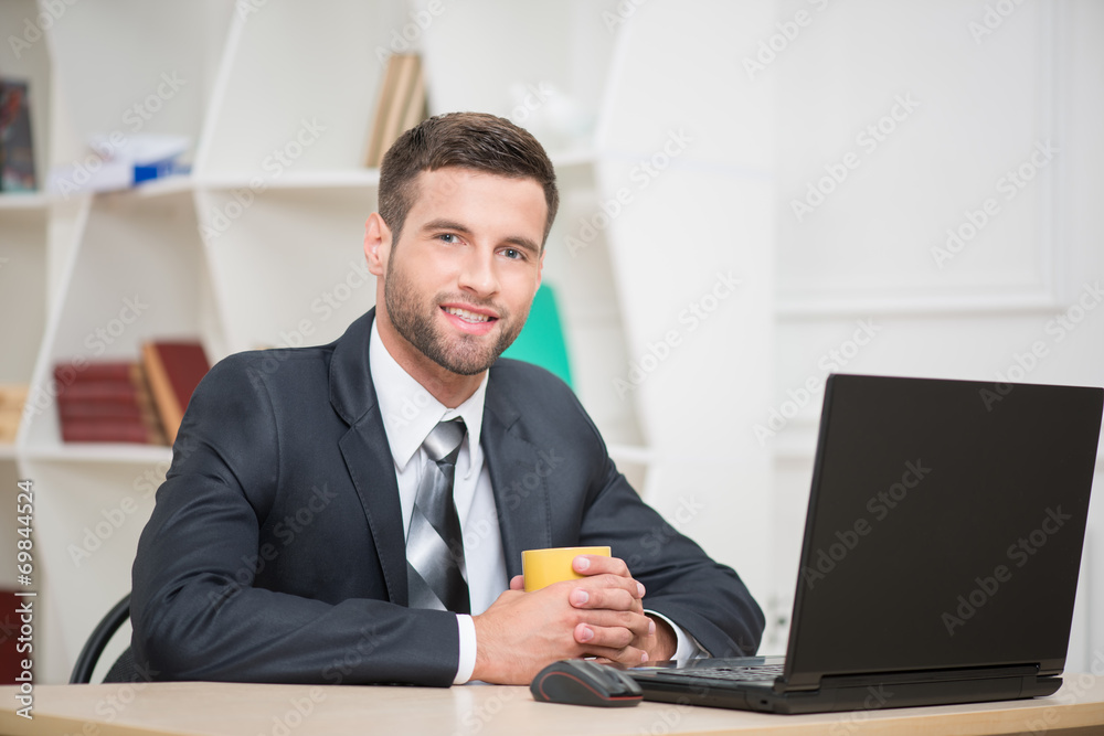 Portrait of handsome businessman enjoying the coffee-break sitti Portrait of handsome businessman enjoying the coffee-break sitti
