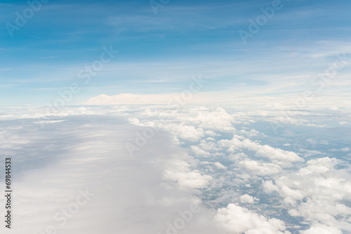 Airplane trace over the clouds © Delicious