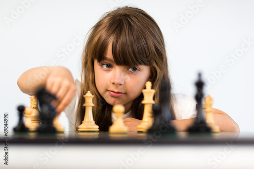 Girl playing chess photo