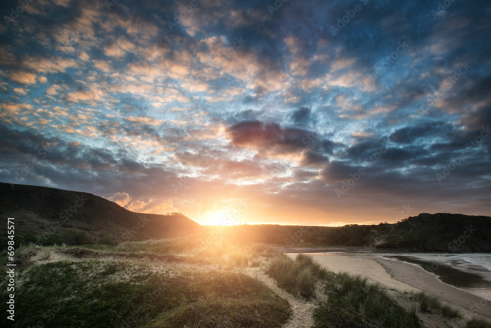 Beautiful Summer sunrise landscape over yellow sandy beach
