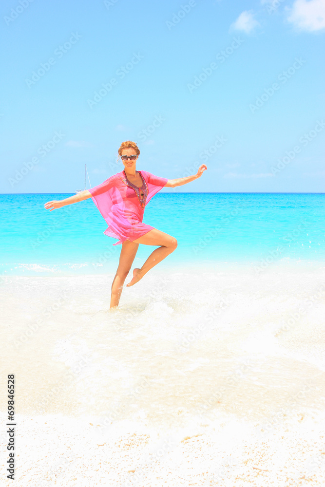 Beautiful young sexy woman by the sea in Greece