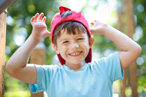 Little boy in red cap mocking