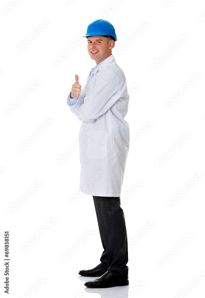 Man in a lab coat and helmet