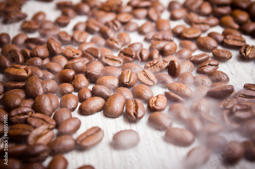 Coffee seeds on wooden surface texture. 