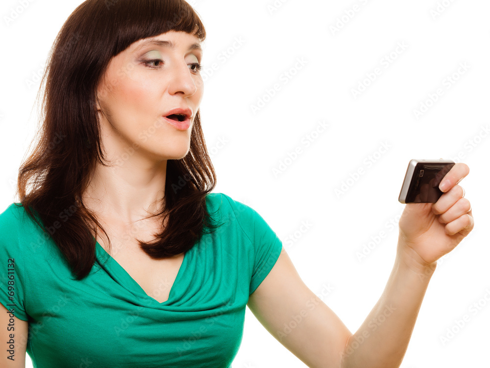 Surprised woman reads message on her mobile phone