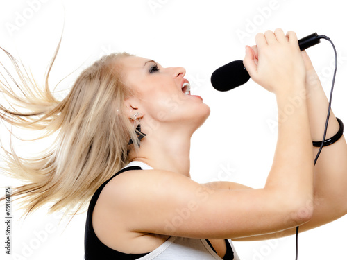 girl singer singing to microphone isolated on white.