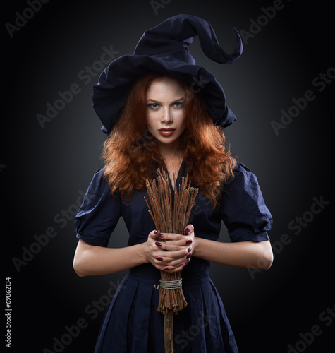 Vászonkép beautiful red-haired girl in a  costume witch