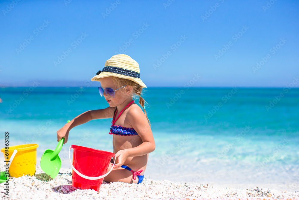 Adorable little girl playing with toys on beach vacation Adorable little girl playing with toys on beach vacation
