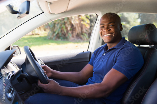 african man inside his new car