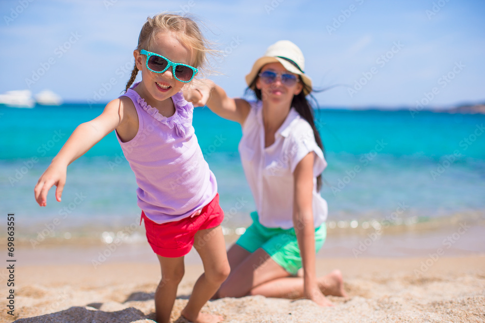 Beautiful mother and her adorable little daughter enjoy summer