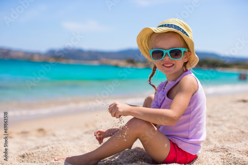 Adorable little girl at tropical beach during European vacation