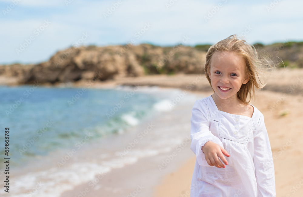 Adorable little girl have fun at tropical beach
