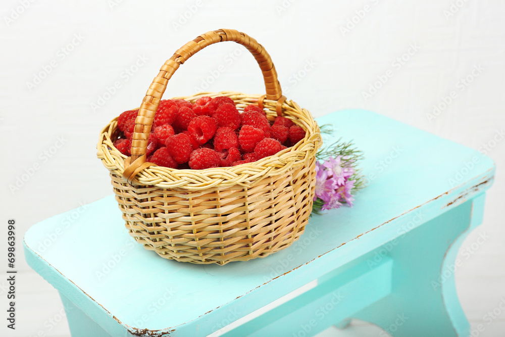 Fresh raspberries in basket on white wall background Fresh raspberries in basket on white wall background