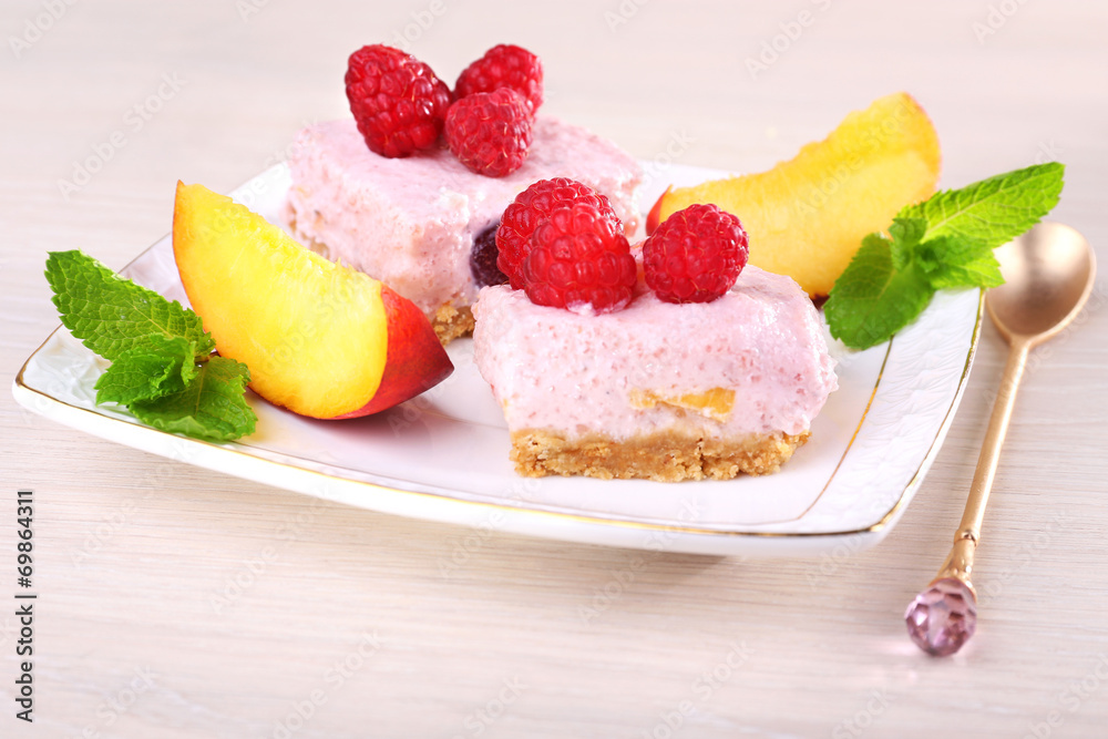 Cake with fruits and berries on plate on wooden background Cake with fruits and berries on plate on wooden background
