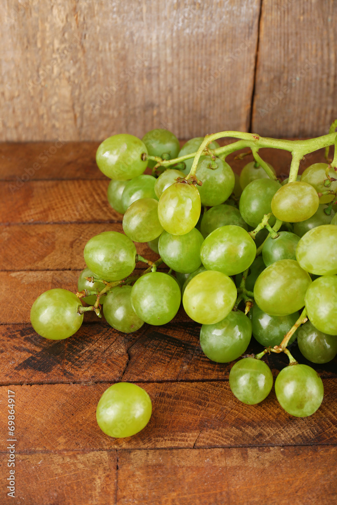 Green grape on wooden table on wooden background Green grape on wooden table on wooden background