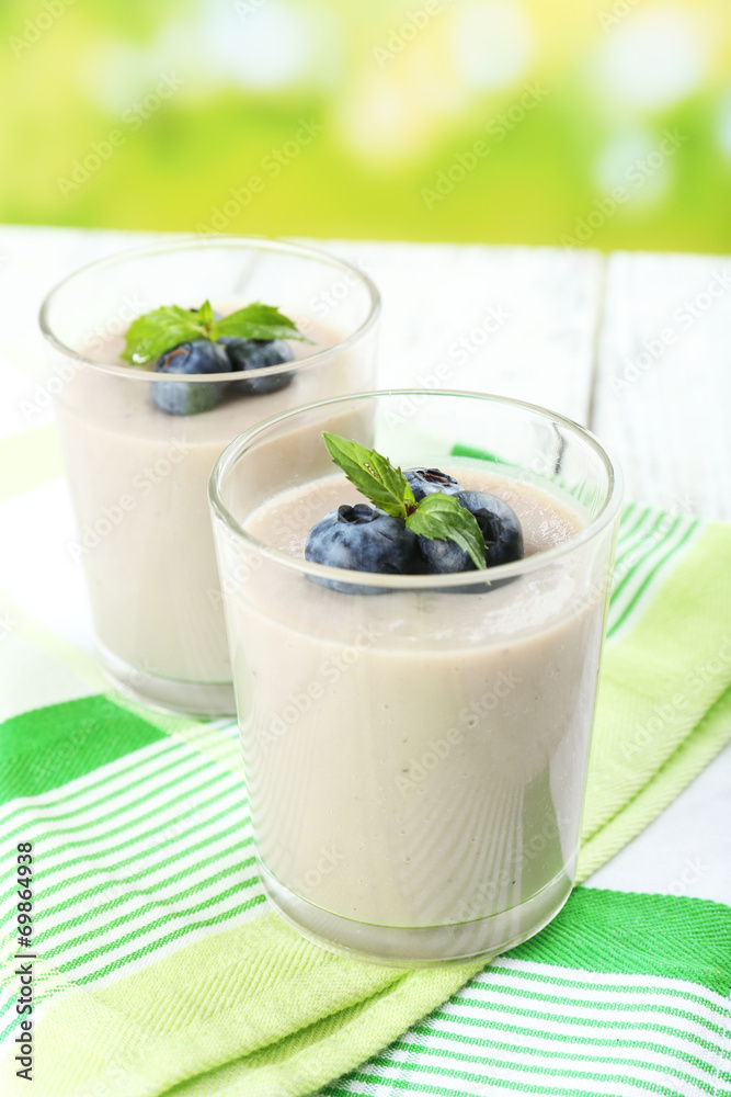 Delicious berry mousse in glasses on table on bright background Delicious berry mousse in glasses on table on bright background