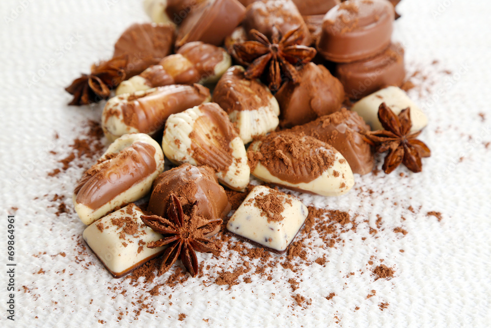 Different kinds of chocolates with spices on white background Different kinds of chocolates with spices on white background