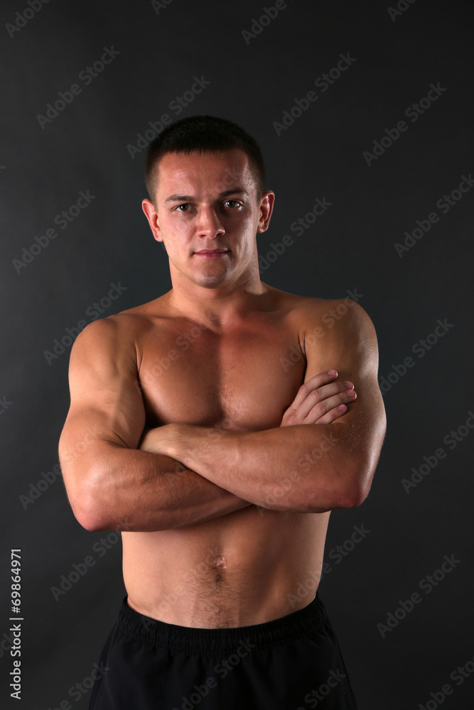 Handsome muscle young man on dark background