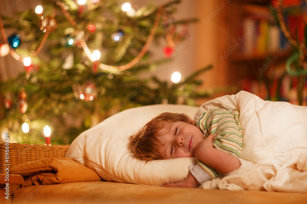 Little cute blond boy sleeping under Christmas tree Little cute blond boy sleeping under Christmas tree