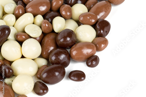 chocolate covered nuts and raisins isolated on white