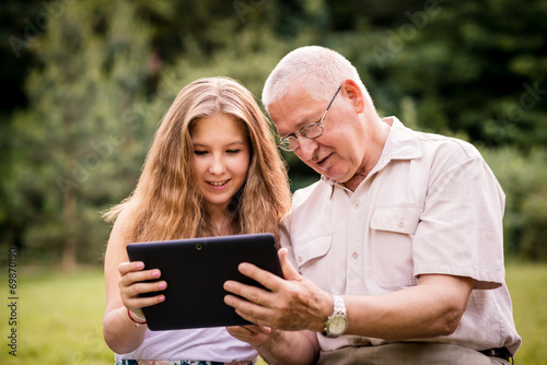Grandchild shows grandfather tablet