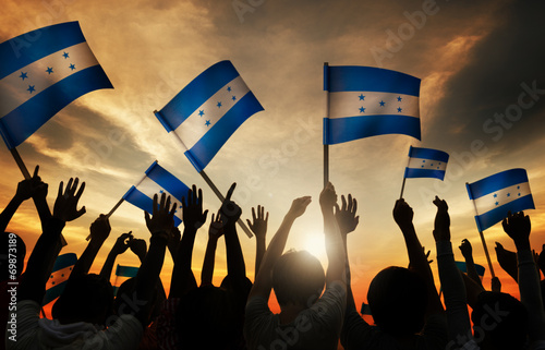 Silhouettes of People Holding Flag of Honduras