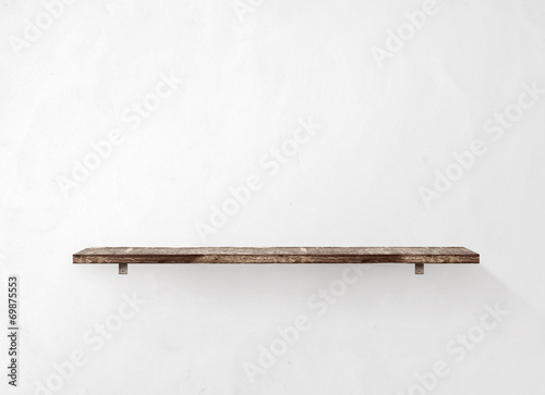 Empty wooden shelf on the wall