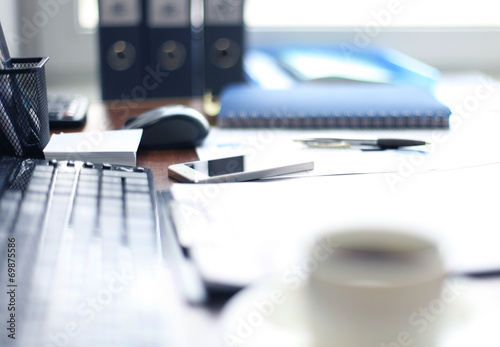 Office supplies and coffee cup on table