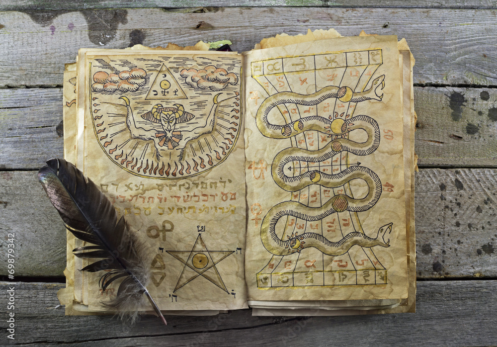 Naklejka premium Magic book on wooden table 2