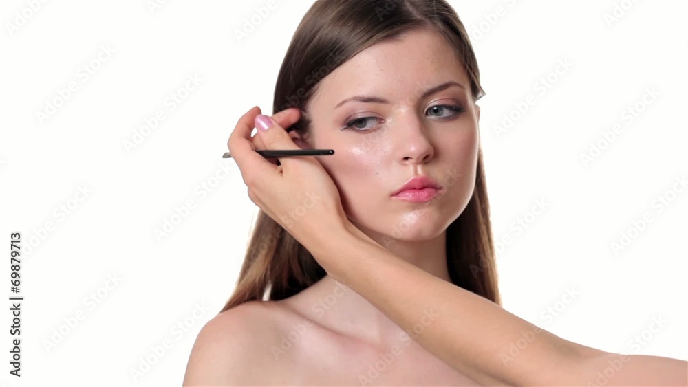 Beautiful woman applying make up on white background Beautiful woman applying make up on white background