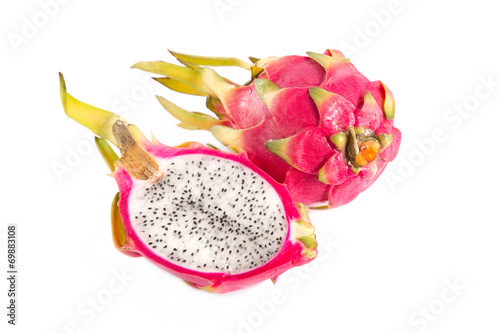 Top view of cut section of dragon fruit and a whole one