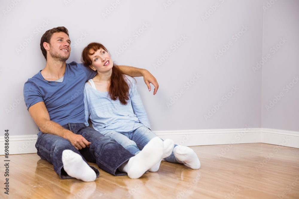 Couple sitting on floor together Couple sitting on floor together