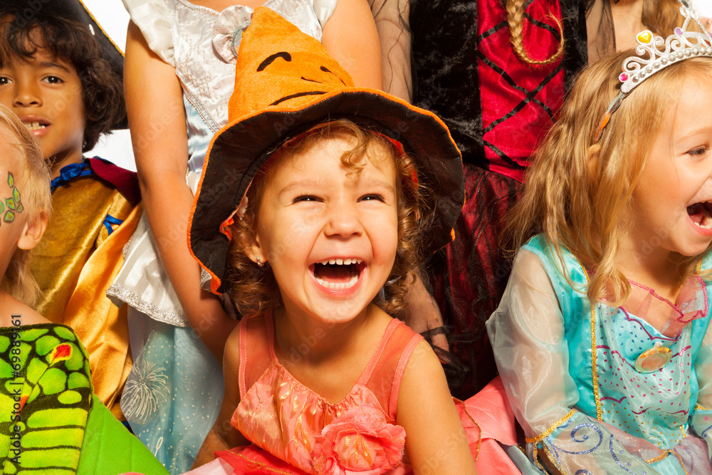 Naklejka premium Laughing girl in Halloween costume with friends