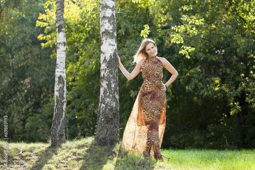 Beautiful blonde in leopard print long dress