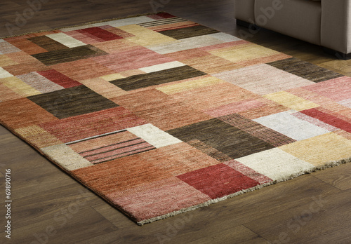 Rug carpet on wooden floor close up photo