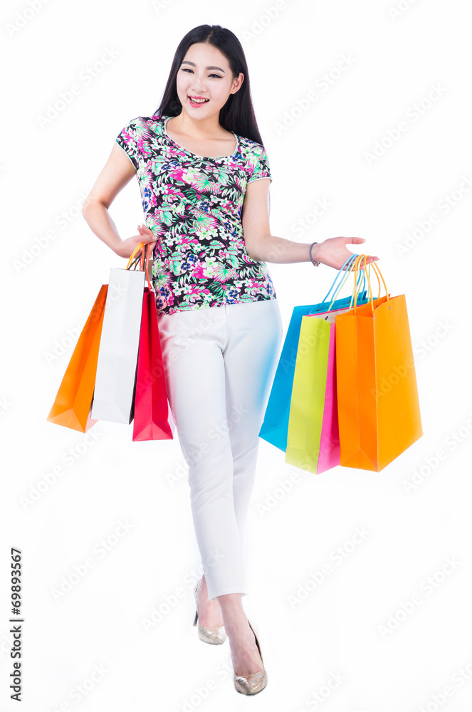 young woman with shopping bags over white background